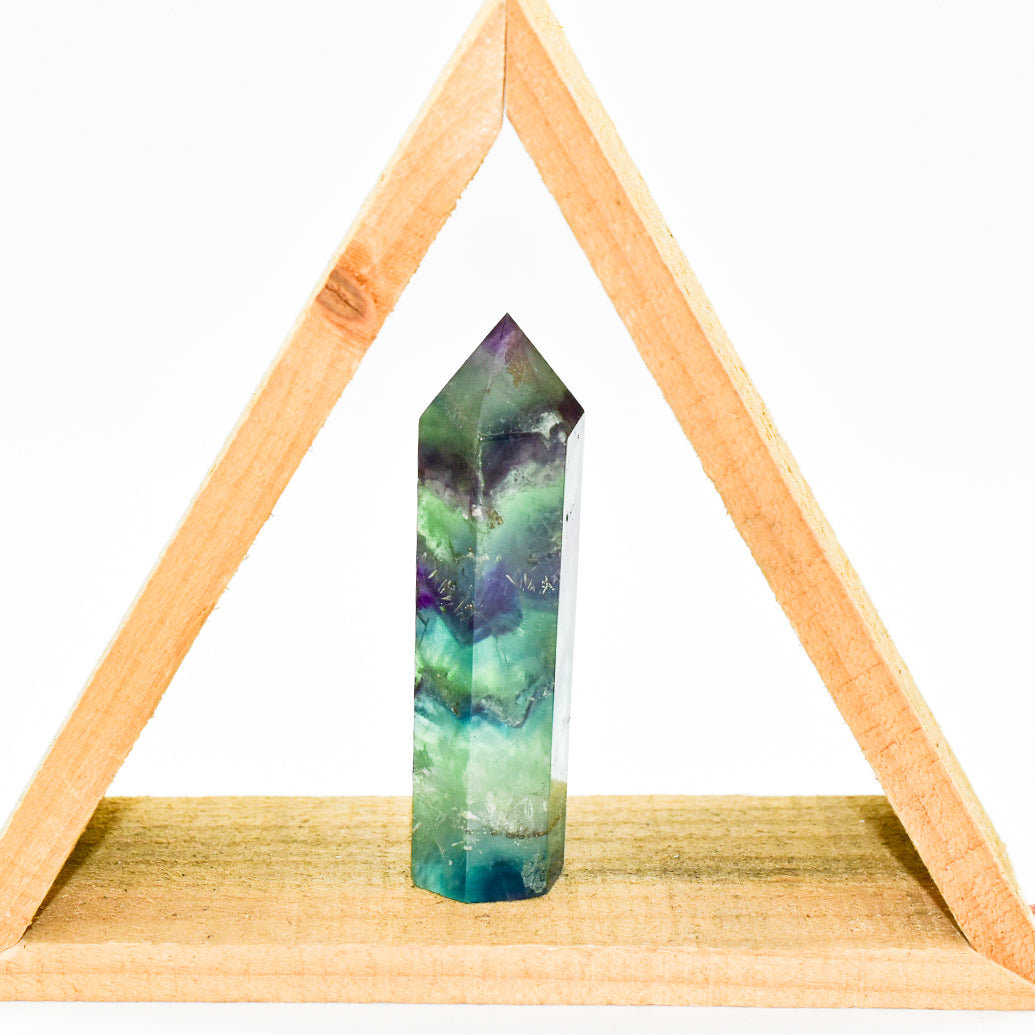 A beautifully polished Fluorite Crystal Point showcasing vibrant colors and unique patterns, ideal for energy healing and meditation.