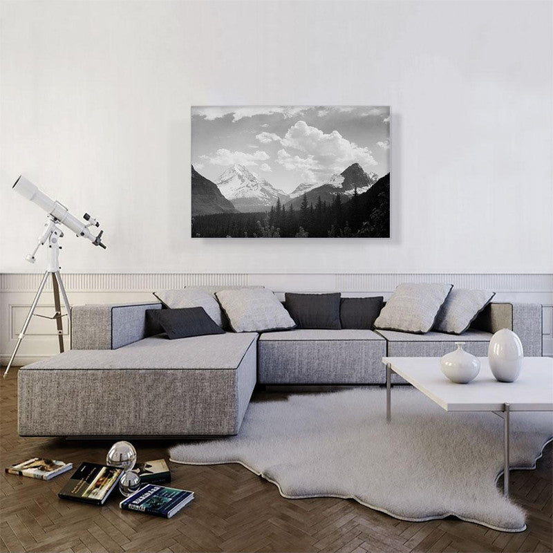 A stunning canvas print of Glacier National Park showcasing majestic mountains, lush forests, and dramatic clouds, perfect for home decor.