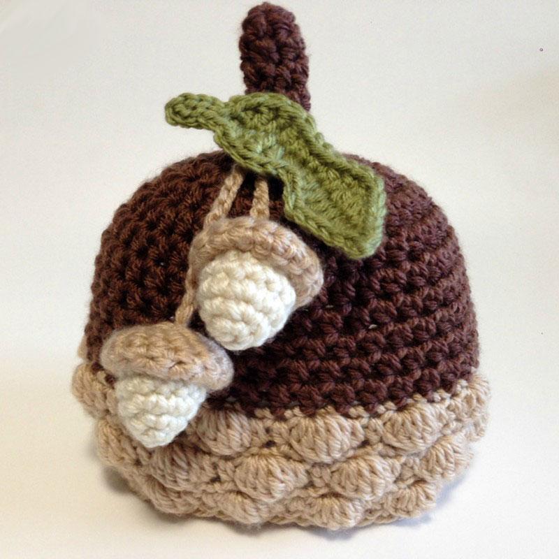 A cozy, pure handmade crochet baby beanie hat in acorn style, perfect for infants aged 0-12 months, showcasing its soft texture and charming design.