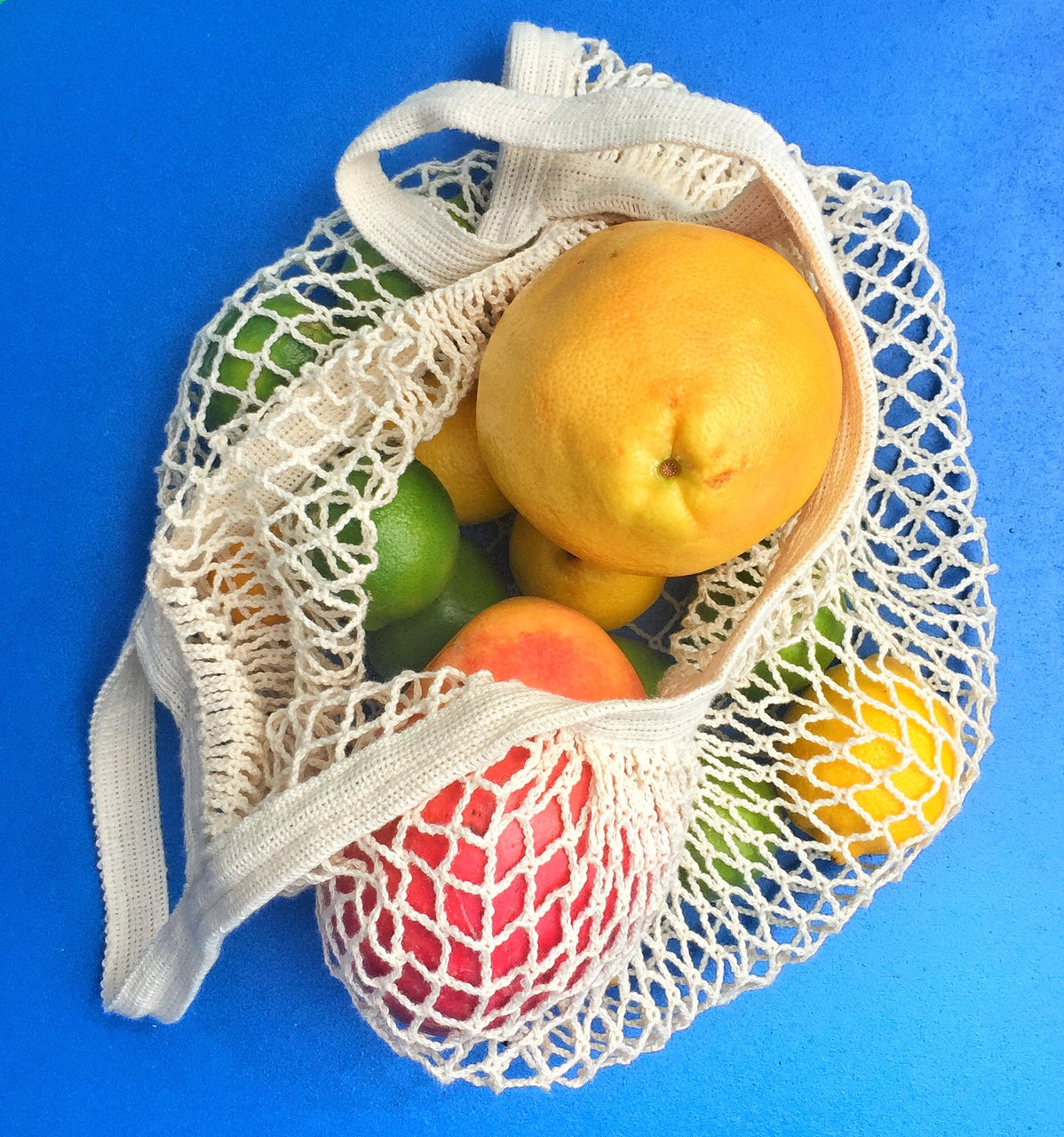 A stylish French Market Tote made of durable cotton string, showcasing its expandable design and natural color, perfect for shopping and travel.