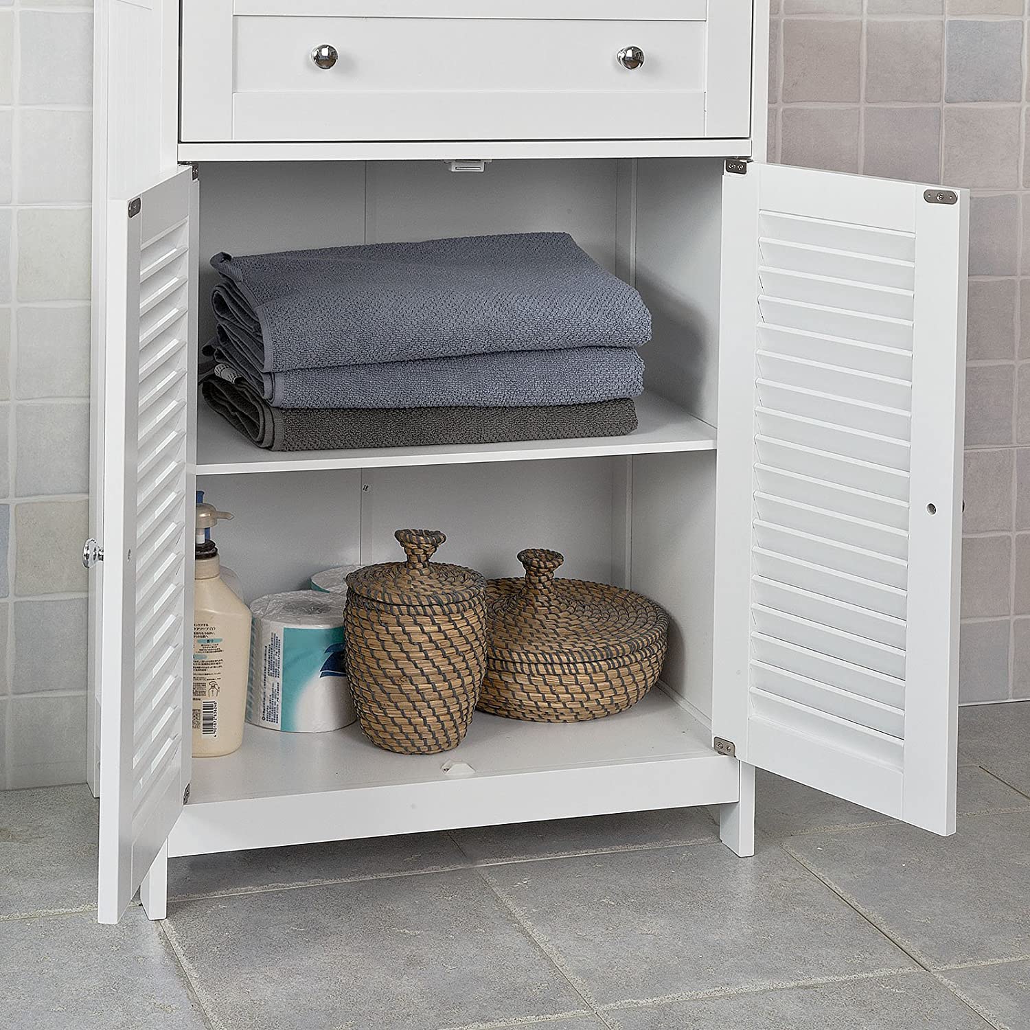 White freestanding storage cabinet with two doors and a drawer, designed for efficient organization in any room.