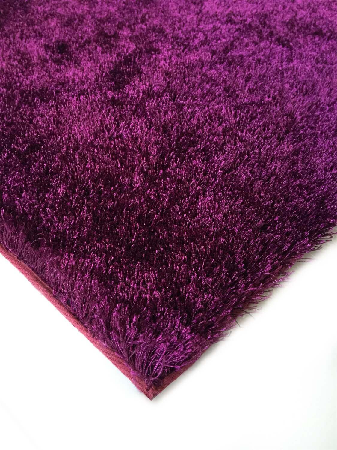 Fuzzy Magenta Area Rug showcasing a soft shaggy texture in a vibrant magenta color, perfect for home decor.