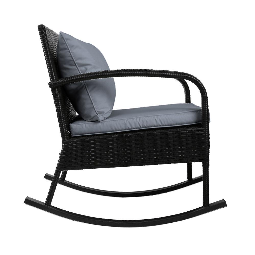Gardeon Outdoor Rocking Chair in black wicker with grey cushions, set in a garden patio environment, showcasing its elegant design and comfort.
