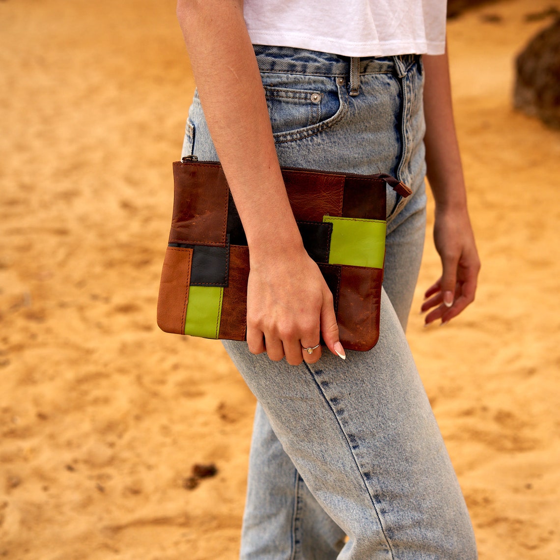 Genuine leather patchwork clutch showcasing unique design and high-quality craftsmanship, perfect for storing essentials.