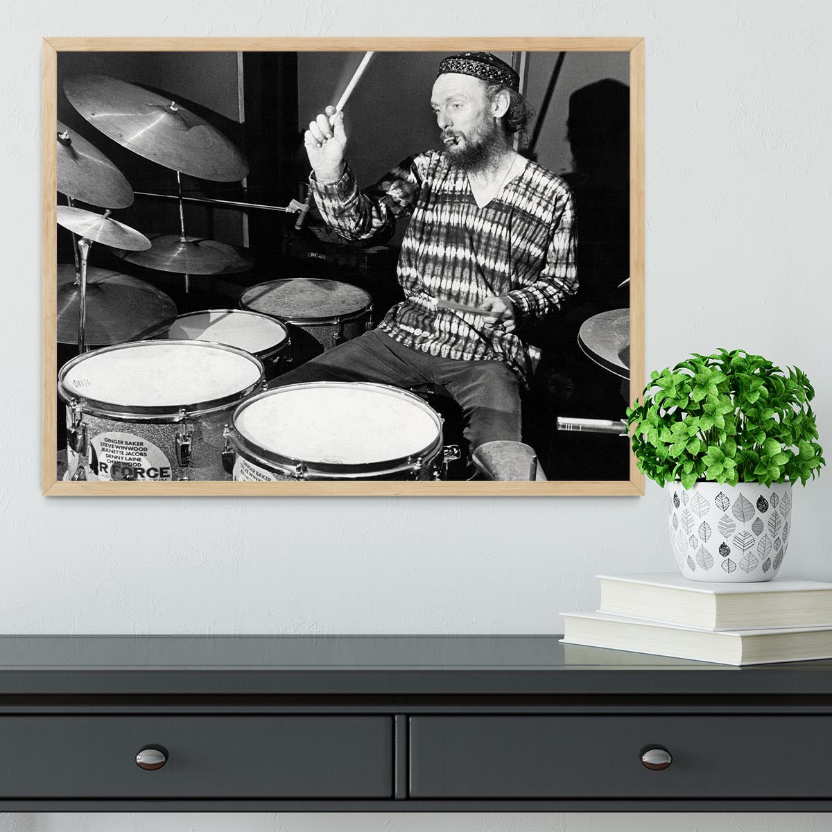 Framed print of Ginger Baker playing drums, showcasing vibrant colors and high-quality craftsmanship.