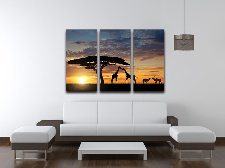 A stunning 3-panel canvas print featuring giraffes and kudu at sunset, showcasing vibrant colors and serene wildlife scenery.