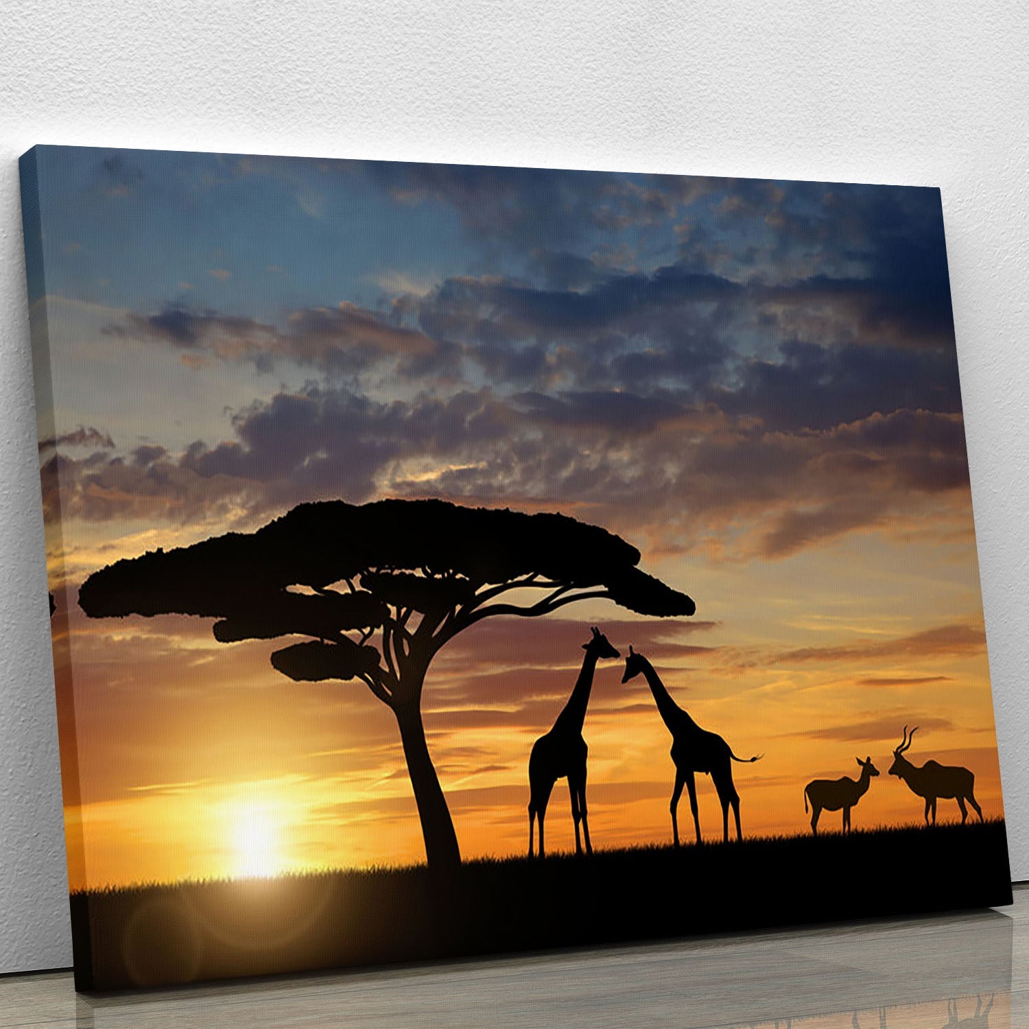 A beautiful canvas print featuring giraffes and kudu at sunset, showcasing vibrant colors and serene wildlife scenery.