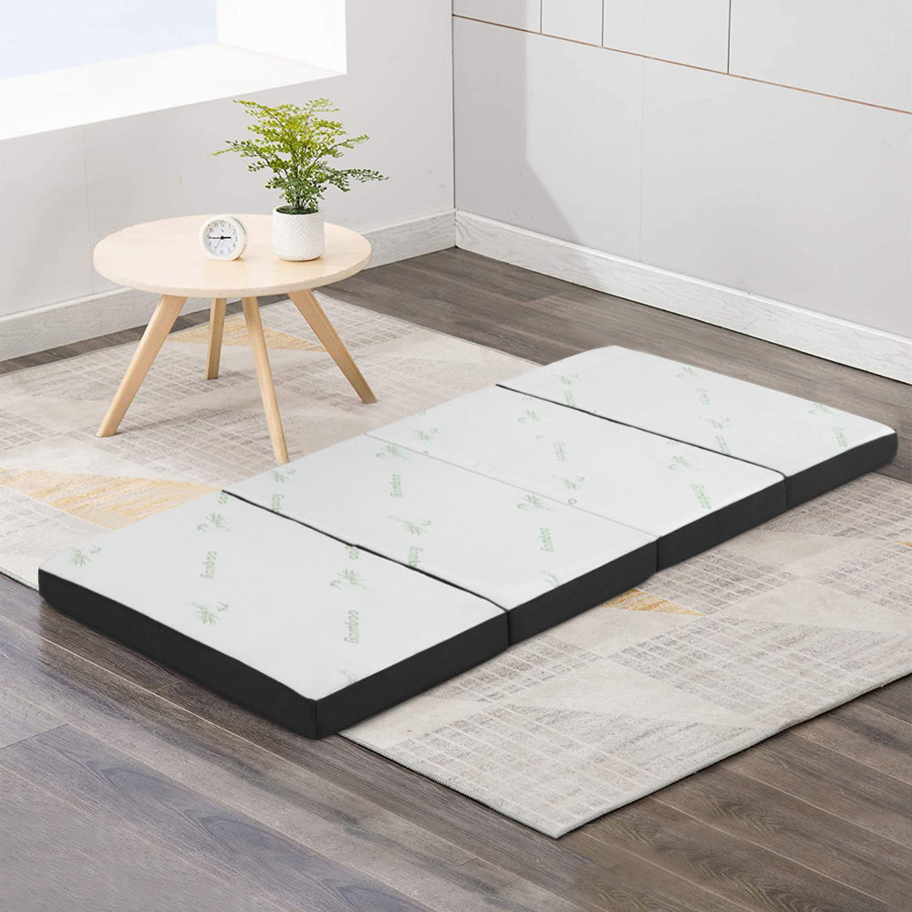 Giselle Bedding Portable Mattress in white and grey, showcasing its foldable design and bamboo fabric cover.