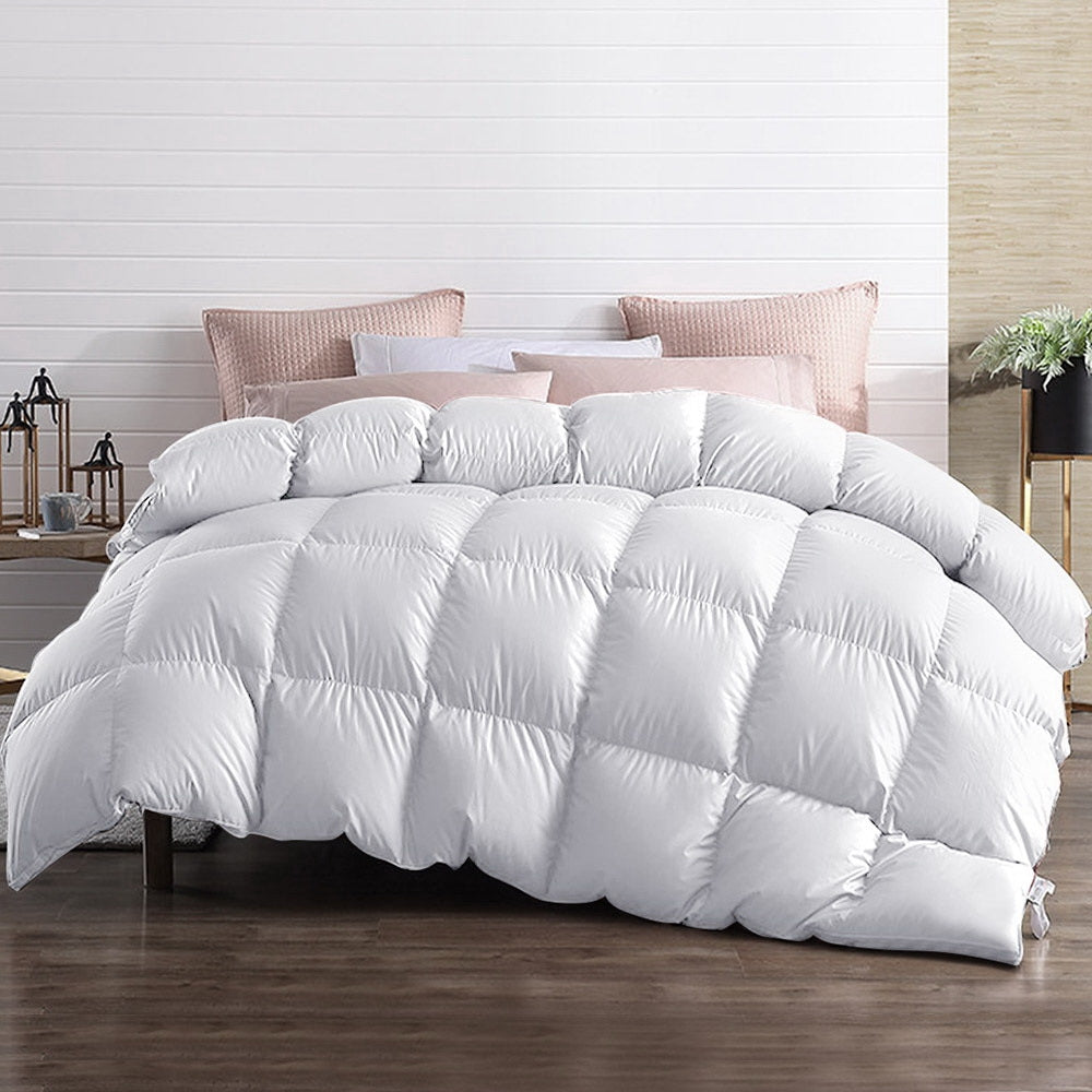 Giselle Bedding Super King 700GSM Goose Down Feather Quilt displayed on a bed, showcasing its luxurious white cotton cover and plush filling.