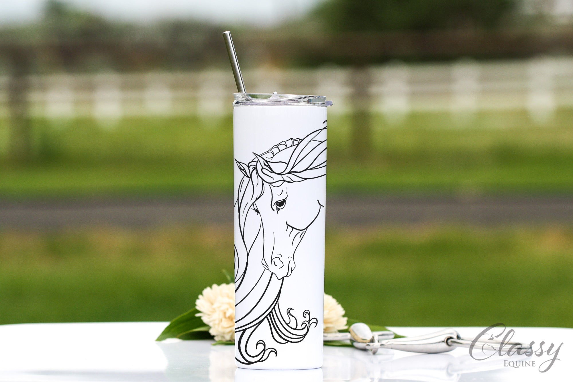 20 oz skinny tumbler featuring a graceful Arabian horse design, stainless steel with a white powder coat, includes a straw and lid.
