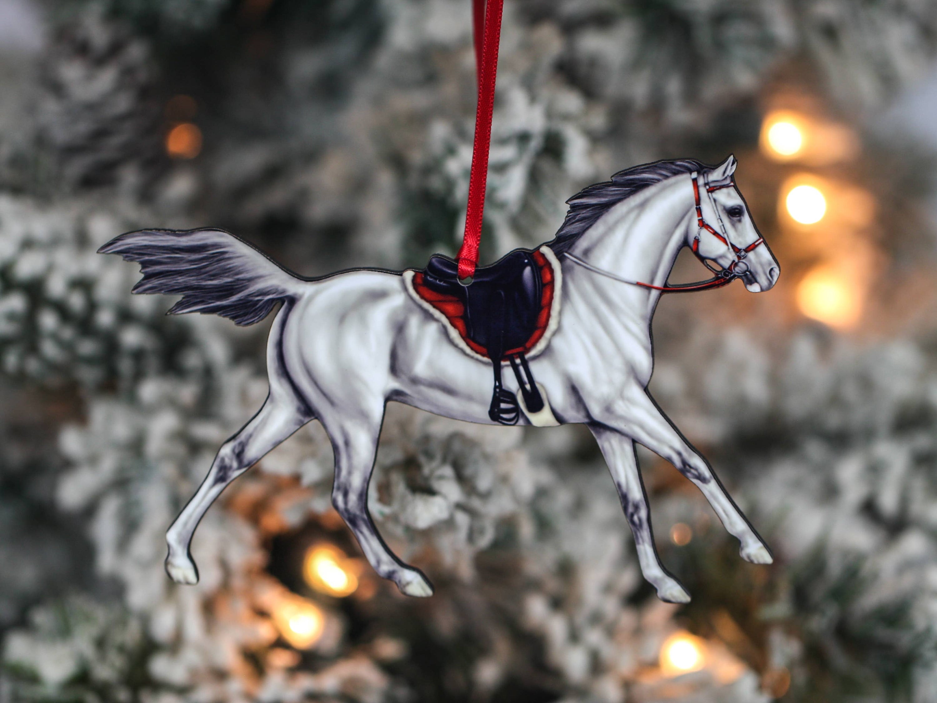 Gray Arabian horse ornament with red and black ribbons, handcrafted from composite wood, perfect for Christmas decor.