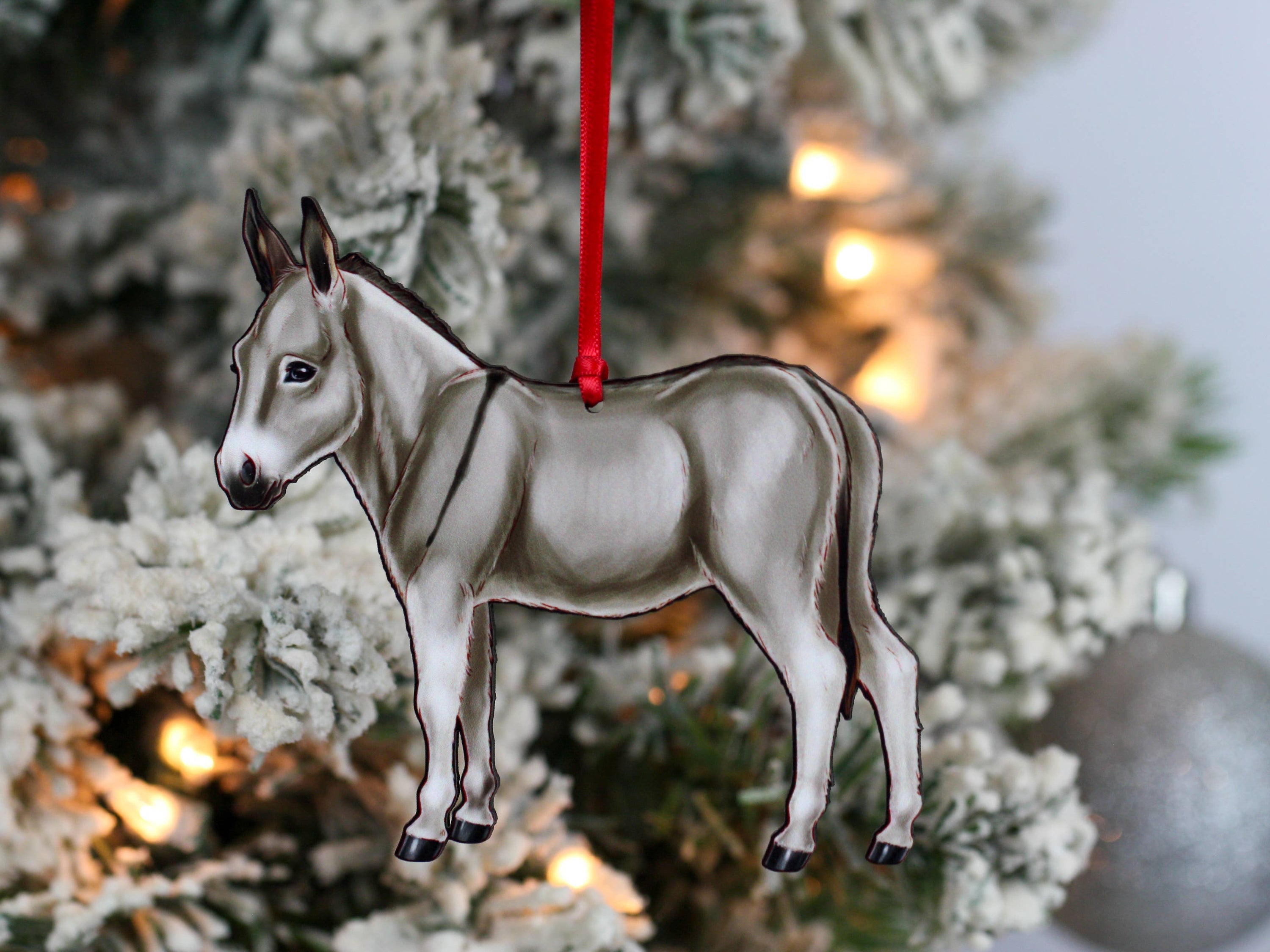 Gray Miniature Donkey Christmas ornament with red and black ribbons, handmade from composite wood, perfect for holiday decor.