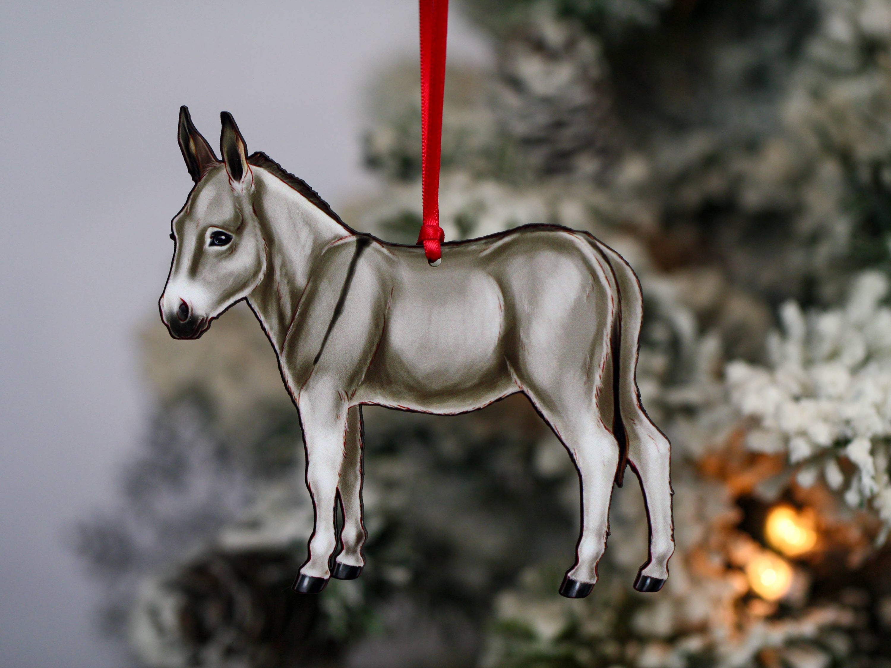 Gray Miniature Donkey Christmas ornament with red and black ribbons, handmade from composite wood, perfect for holiday decor.
