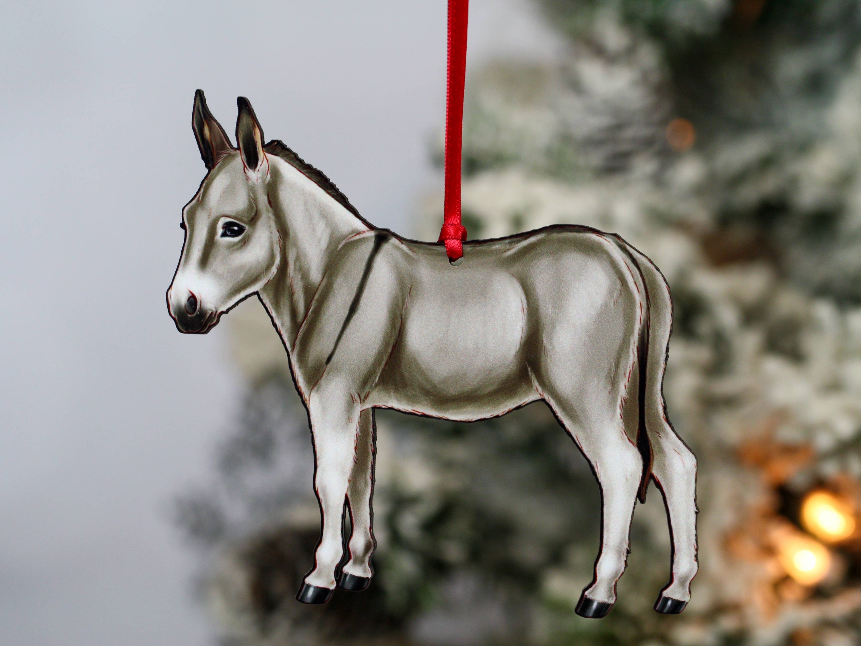 Gray Miniature Donkey Christmas ornament with red and black ribbons, handmade from composite wood, perfect for holiday decor.