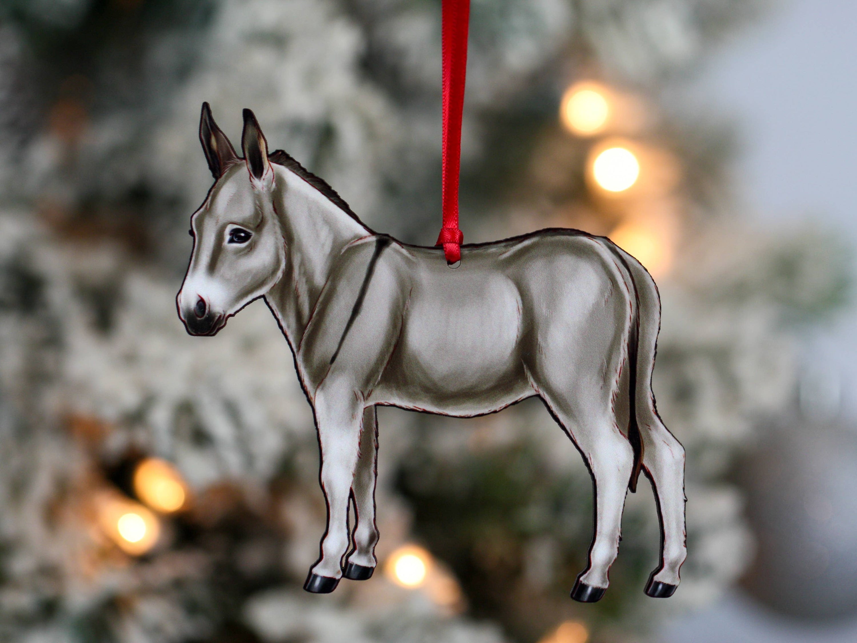 Gray Miniature Donkey Christmas ornament with red and black ribbons, handmade from composite wood, perfect for holiday decor.