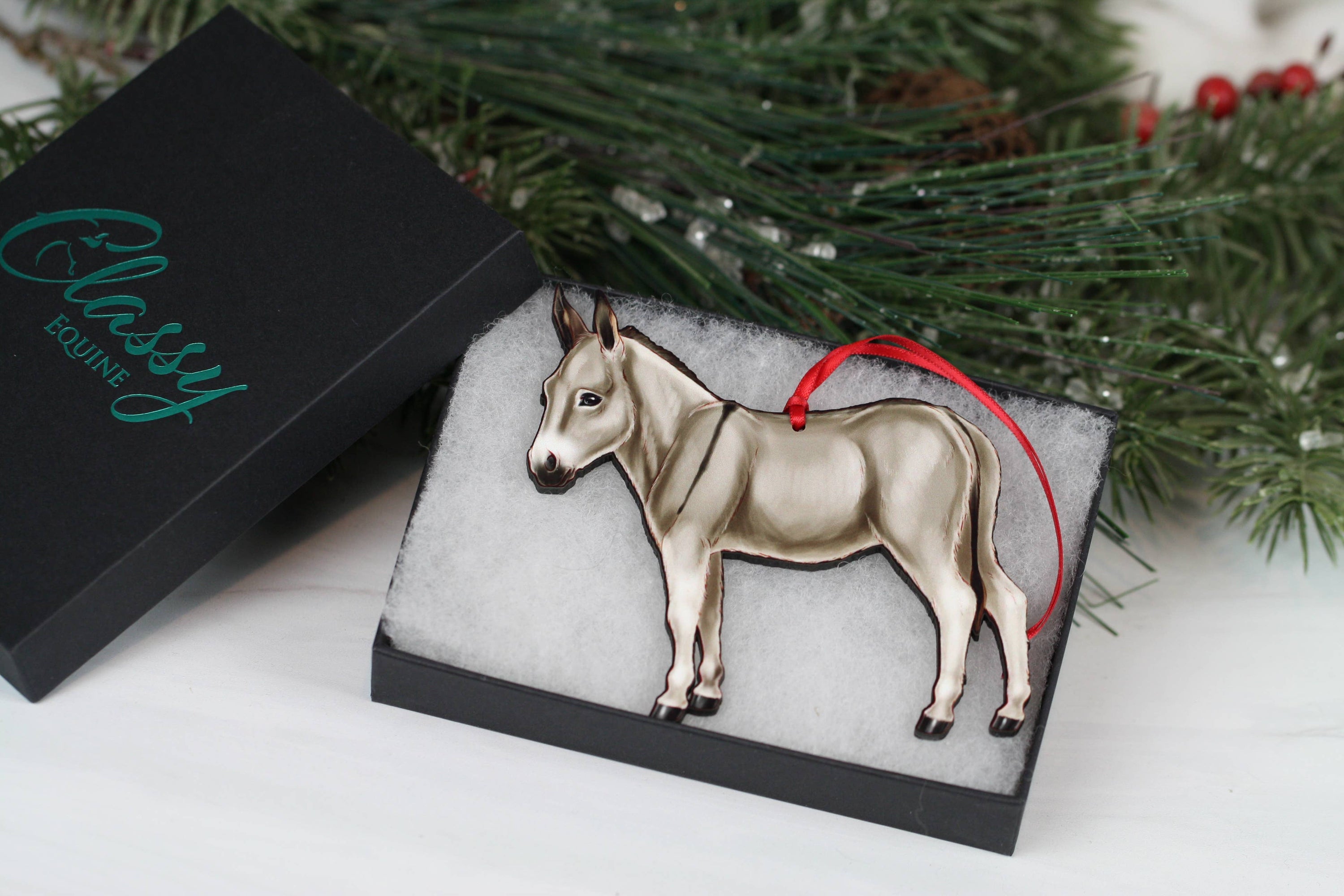 Gray Miniature Donkey Christmas ornament with red and black ribbons, handmade from composite wood, perfect for holiday decor.
