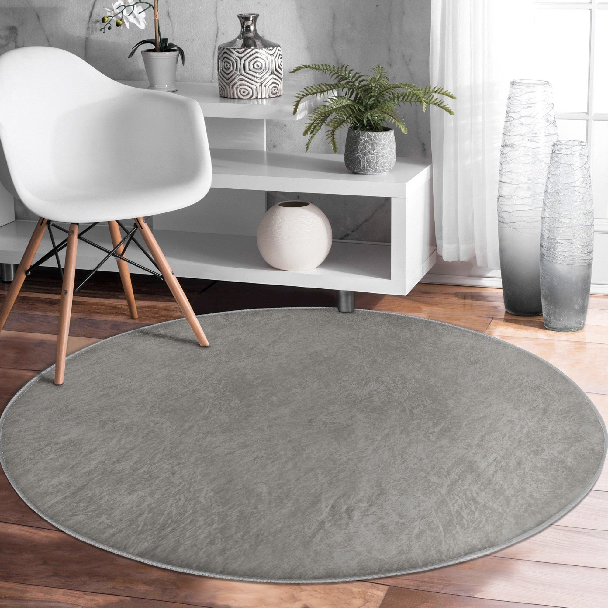 A stylish grey round rug with a soft velvet texture, perfect for home decor and easy maintenance.