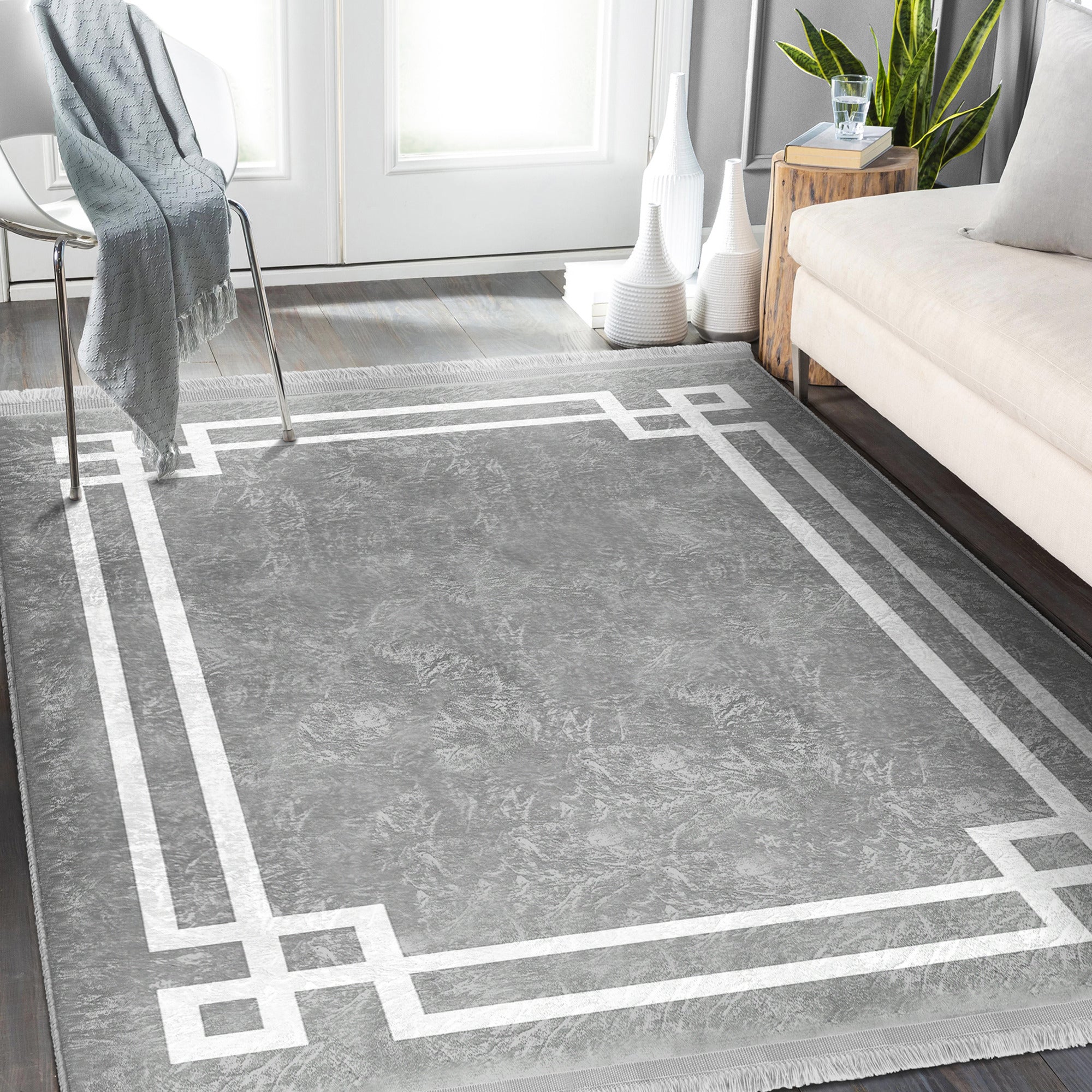 Grey modern area rug with intricate patterns and fringes, showcasing a soft texture suitable for home decoration.