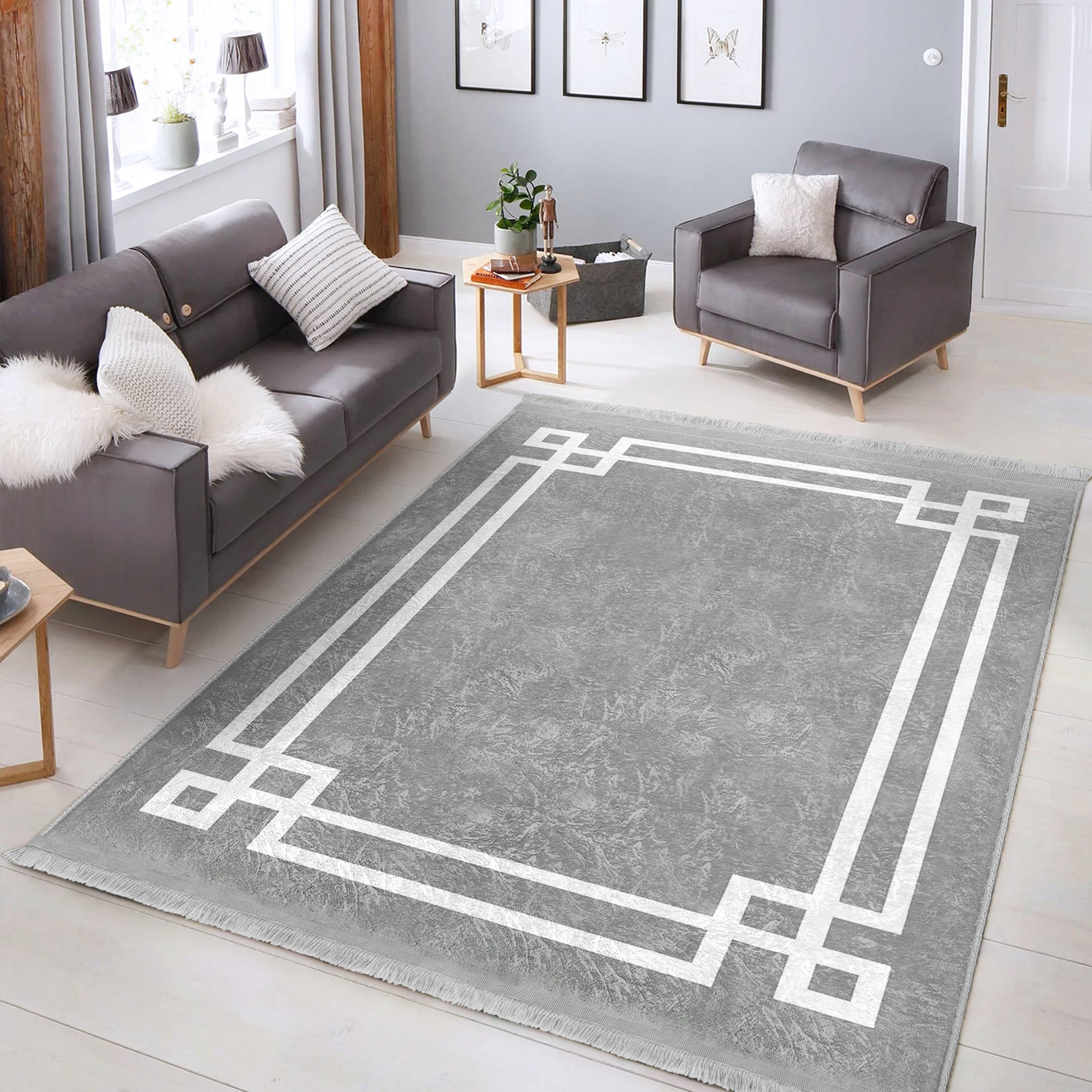 Grey modern area rug with intricate patterns and fringes, showcasing a soft texture suitable for home decoration.