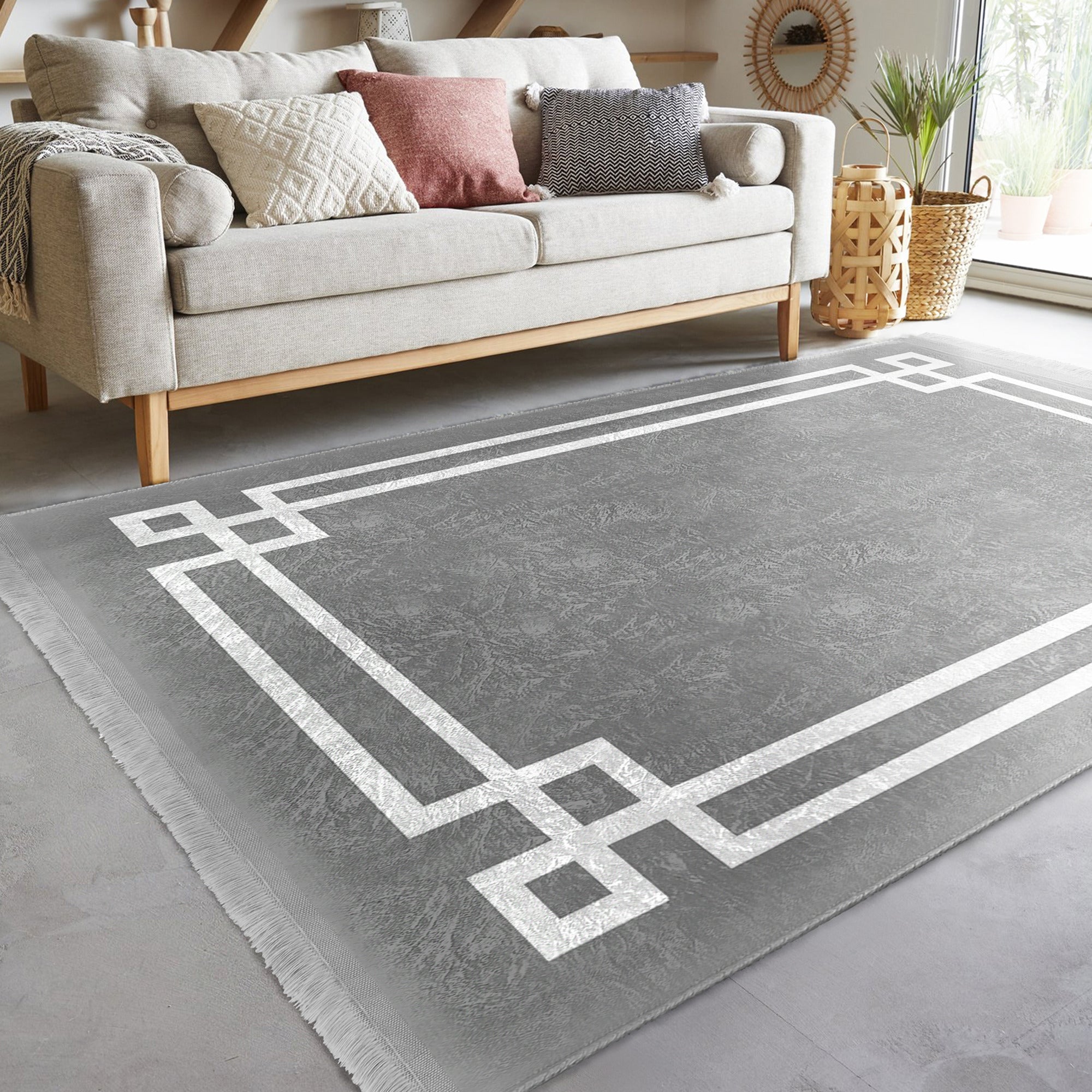 Grey modern area rug with intricate patterns and fringes, showcasing a soft texture suitable for home decoration.