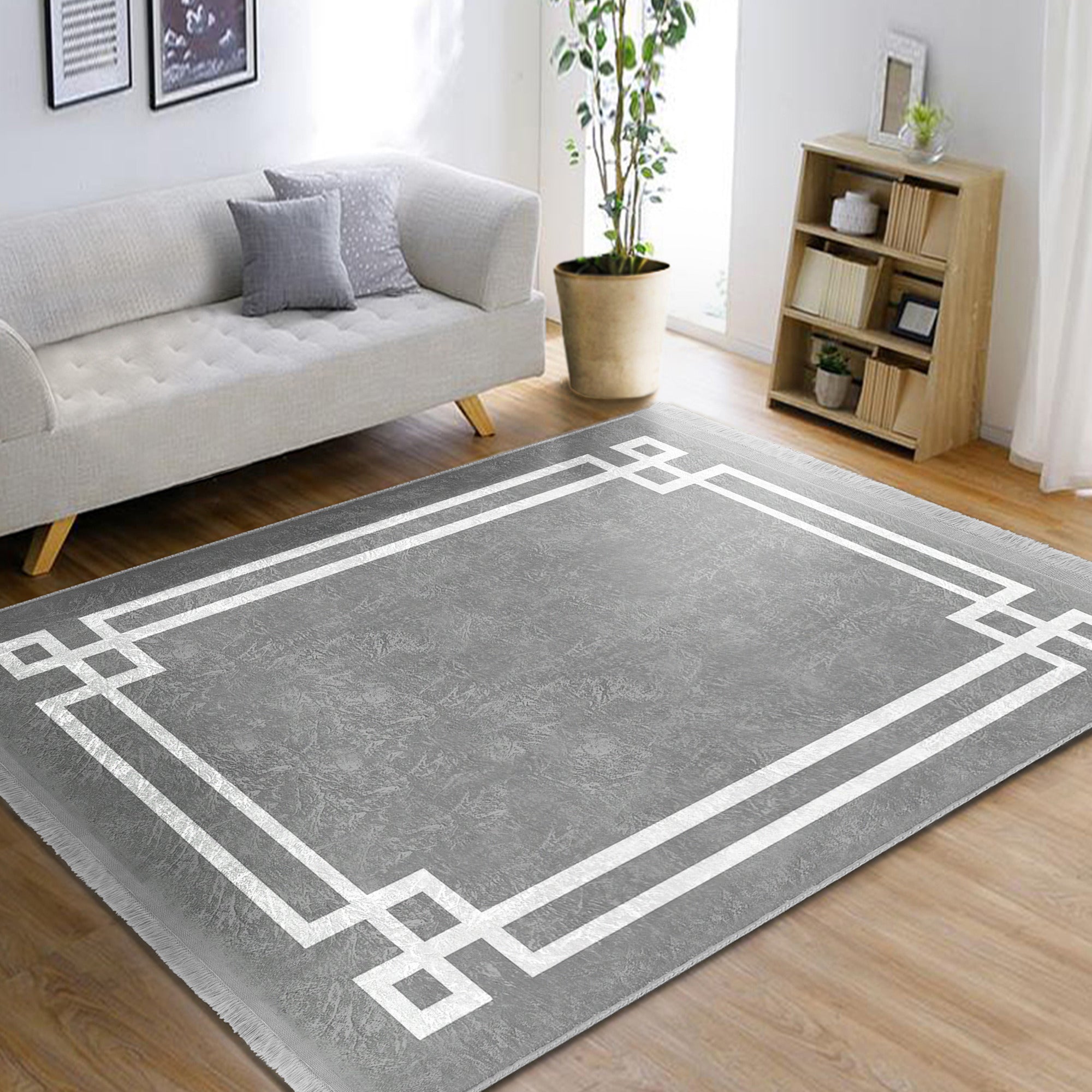 Grey modern area rug with intricate patterns and fringes, showcasing a soft texture suitable for home decoration.