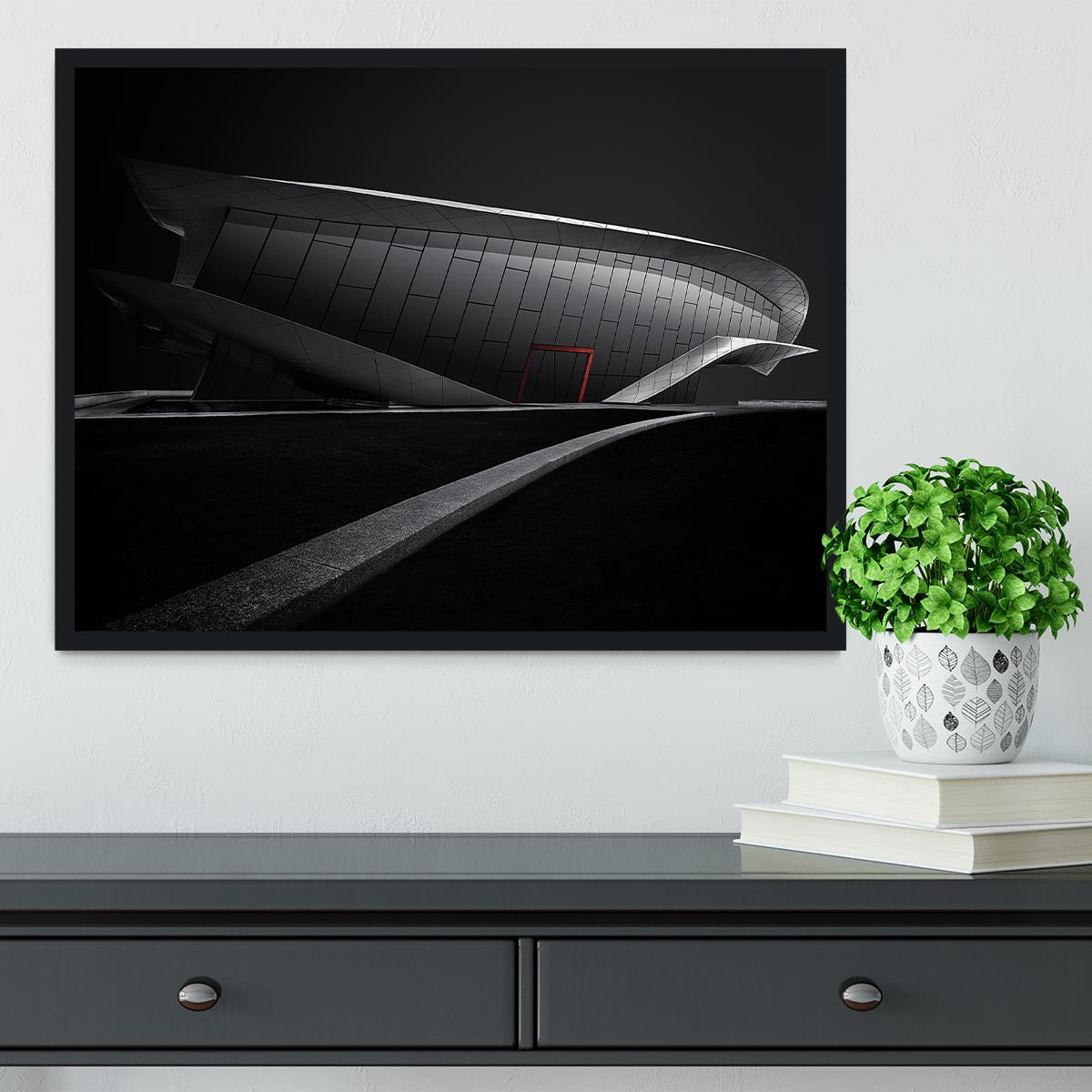 Framed print of greyscale architecture with a touch of red, showcasing a modern design in a stylish frame.