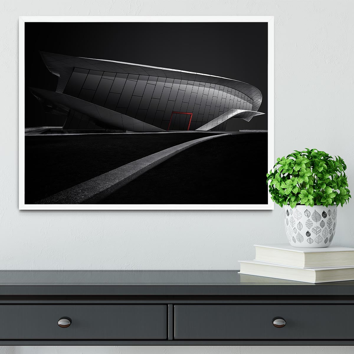 Framed print of greyscale architecture with a touch of red, showcasing a modern design in a stylish frame.