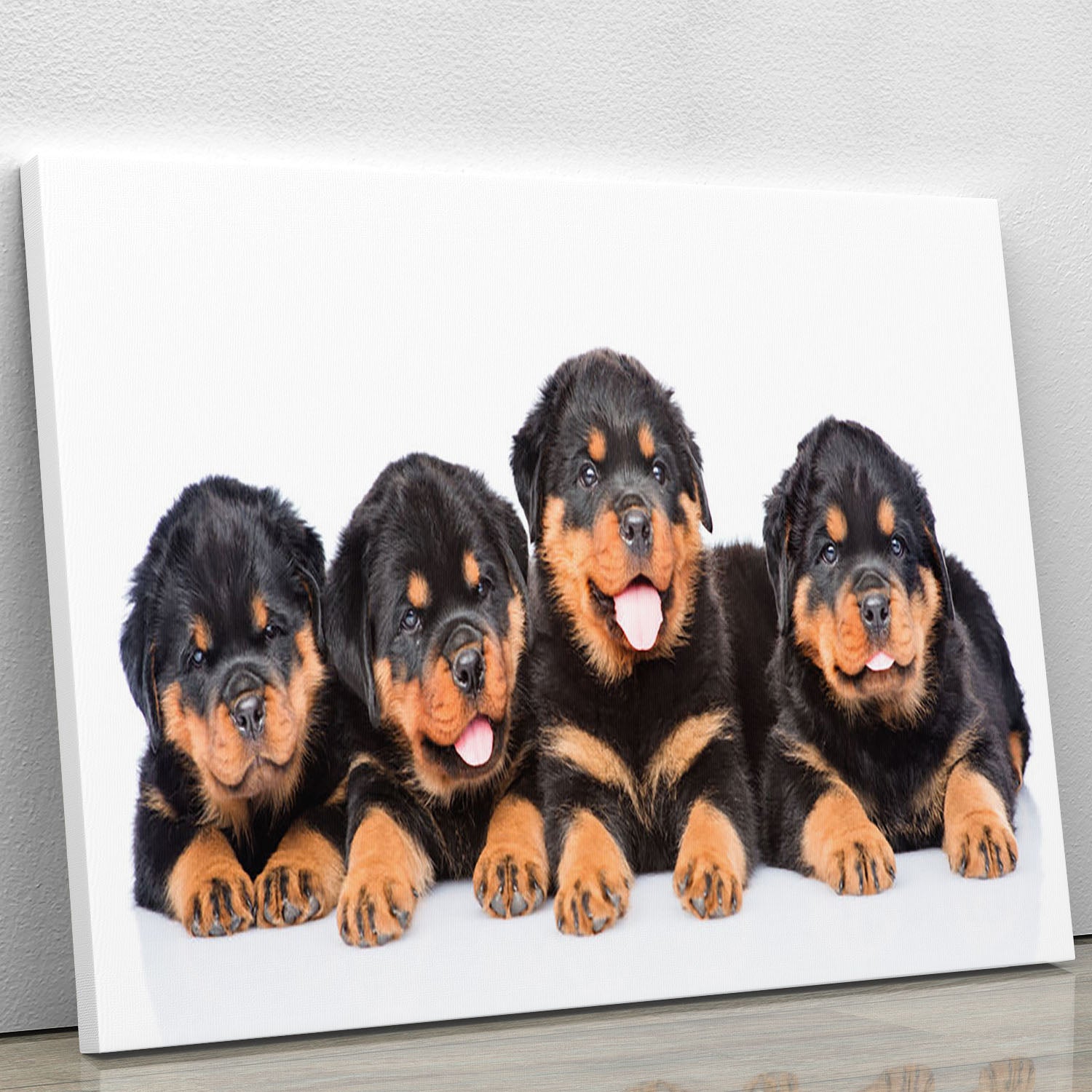 A vibrant canvas print featuring a group of playful Rottweiler puppies, showcasing their adorable expressions and playful nature.