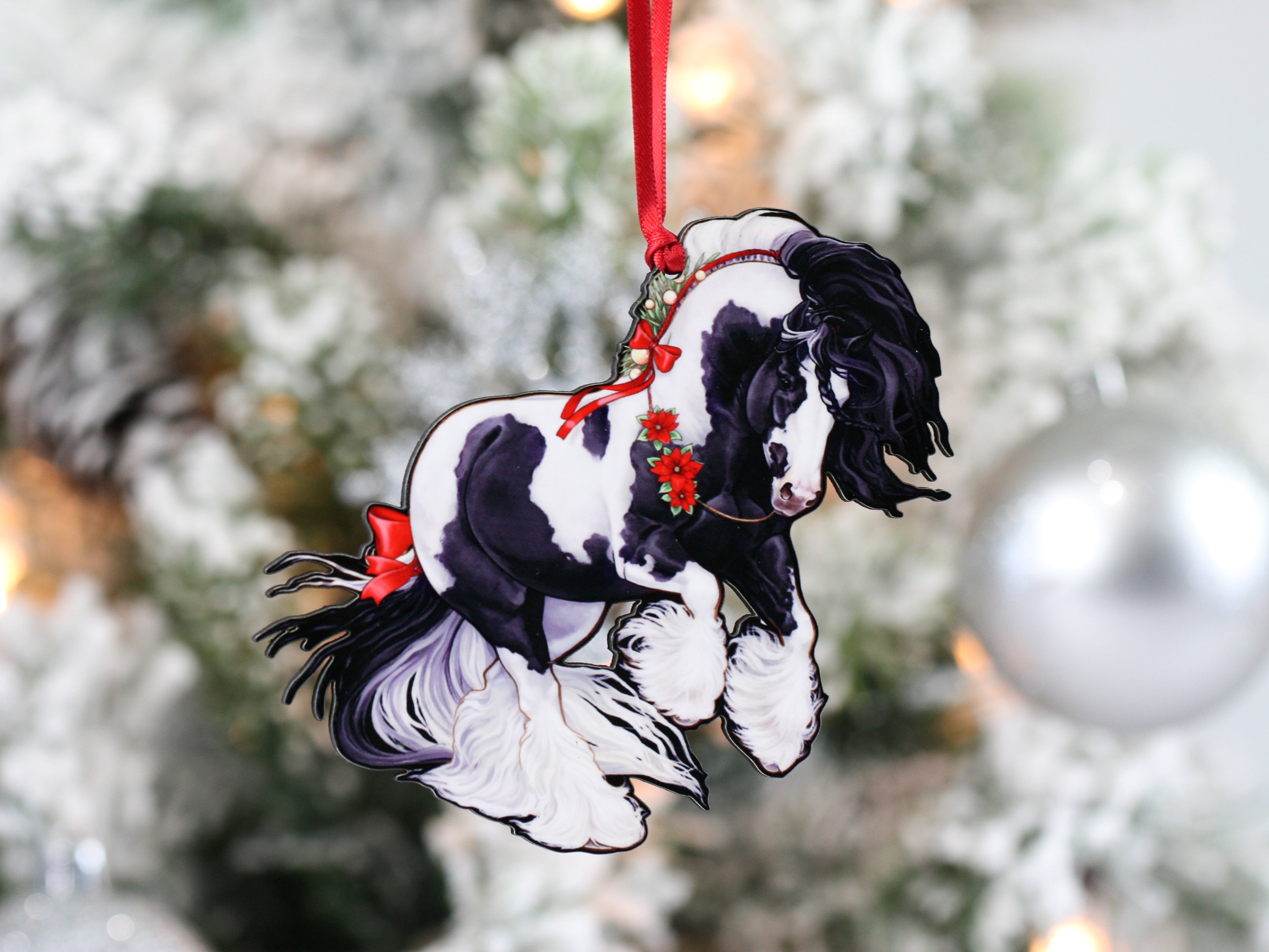 Gypsy Cob Horse Christmas Ornament in black and white tobiano design with red ribbons and Christmas baubles, perfect for holiday decor.