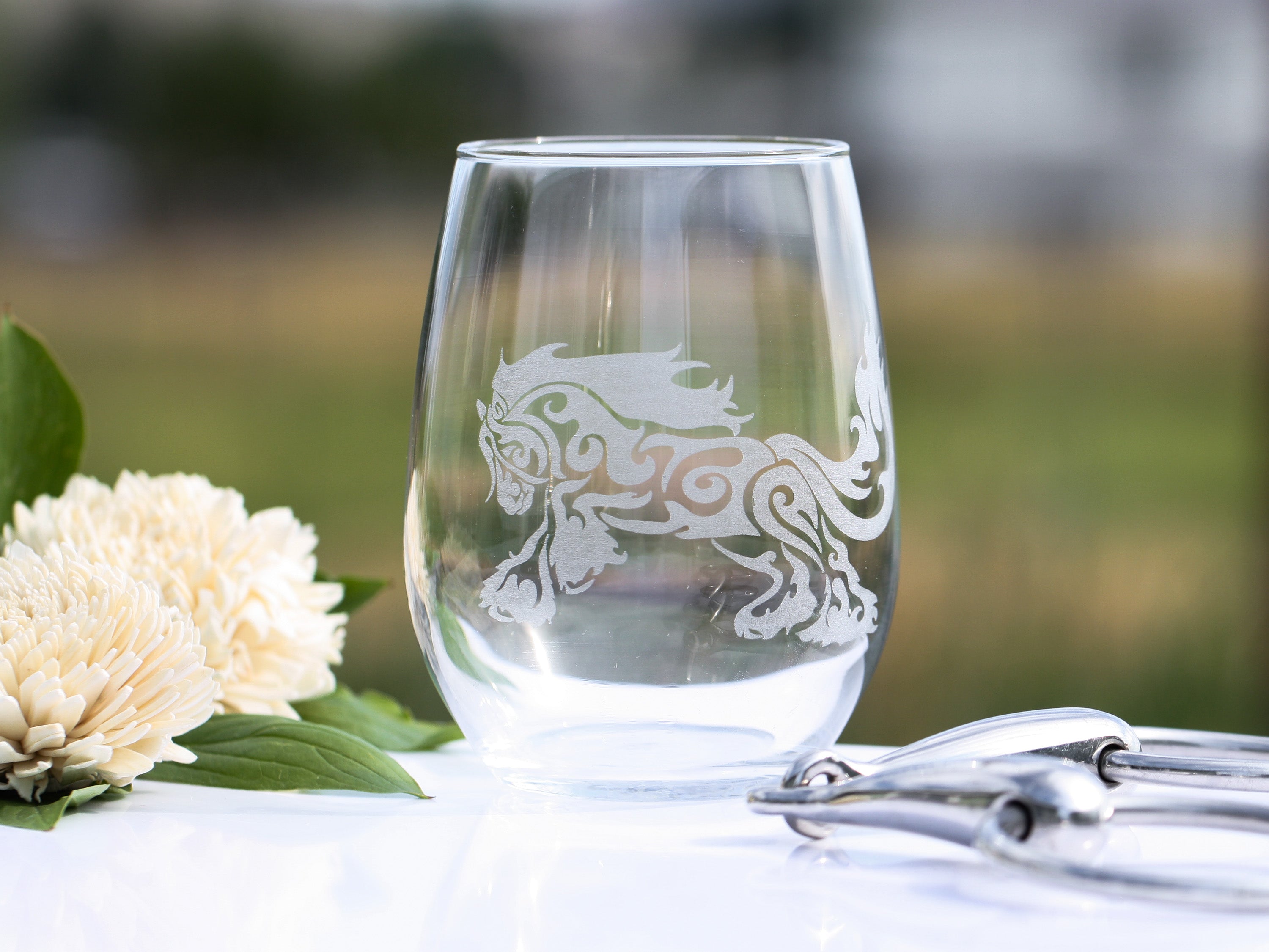 A set of Gypsy Horse Romp stemless wine glasses featuring tribal designs, perfect for stylish dining.