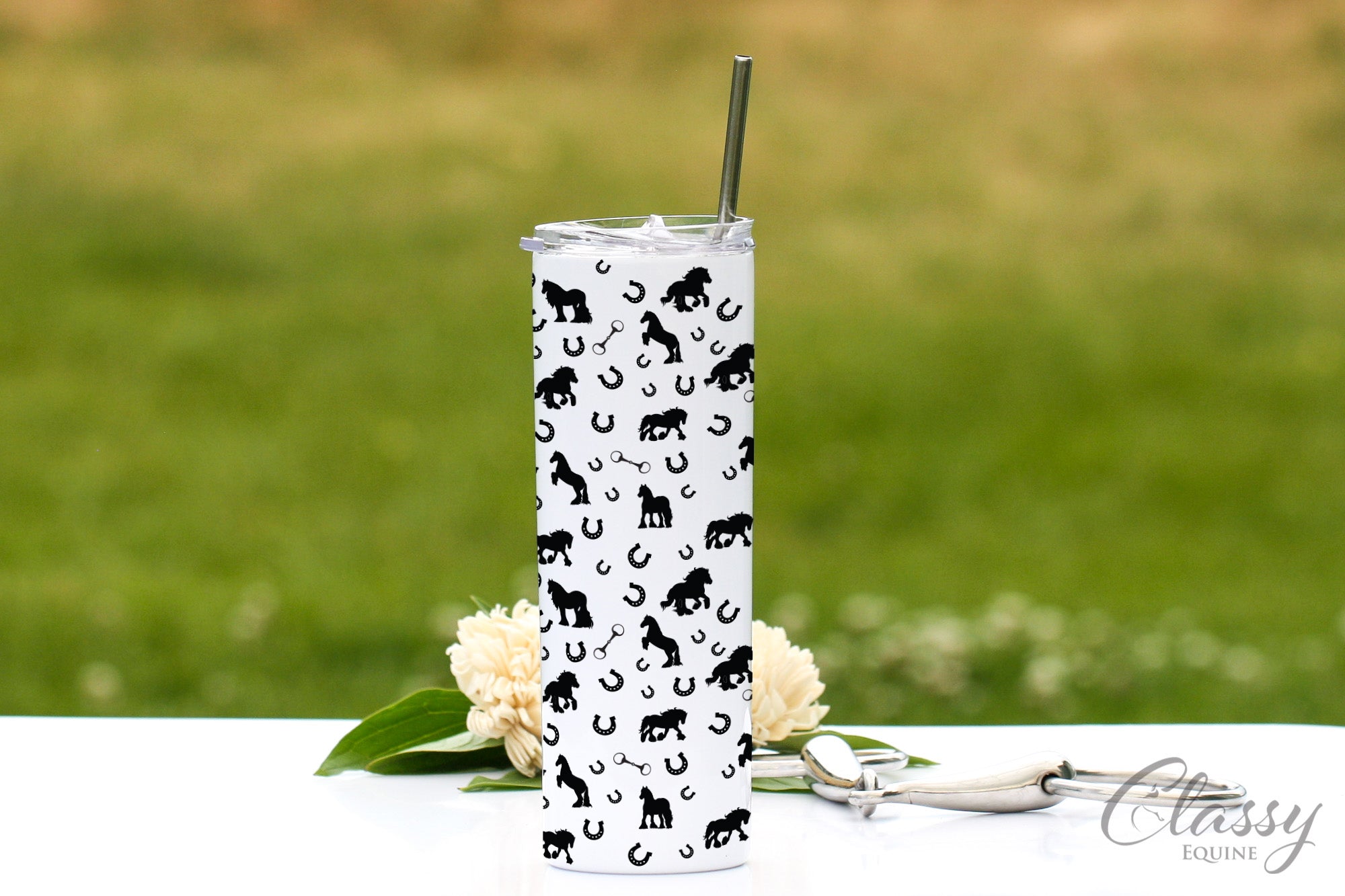 Gypsy Horses All Around 20 oz skinny tumbler featuring horse silhouettes and snaffle bit design, with a stainless steel straw and lid.