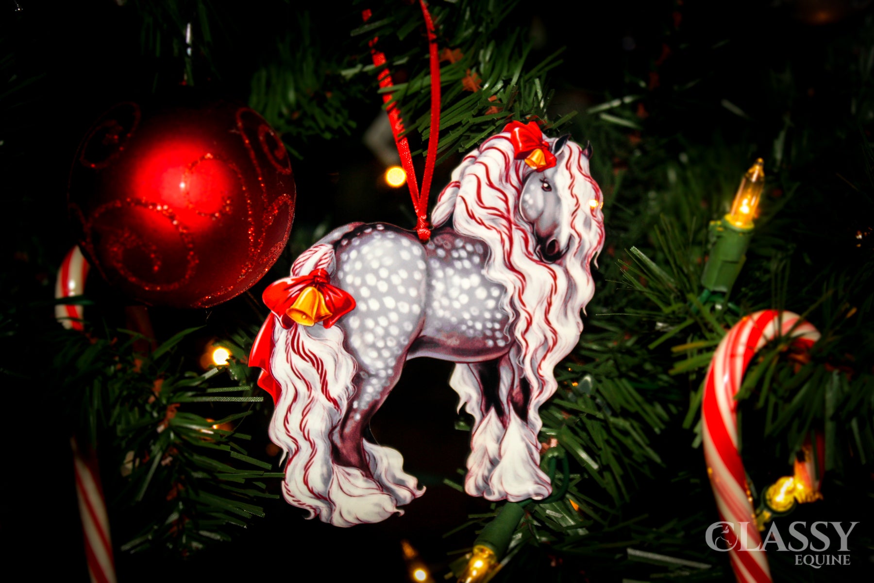 Dapple gray Gypsy Vanner horse Christmas ornament with ribbons and bells, perfect for holiday decor.