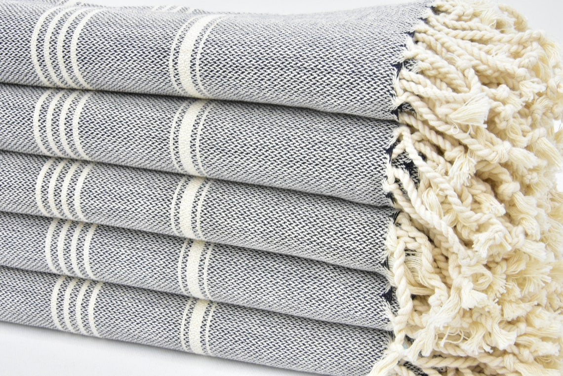 A stylish Hammam towel made from 100% Turkish cotton, featuring a classic herringbone pattern, perfect for beach, yoga, and home use.