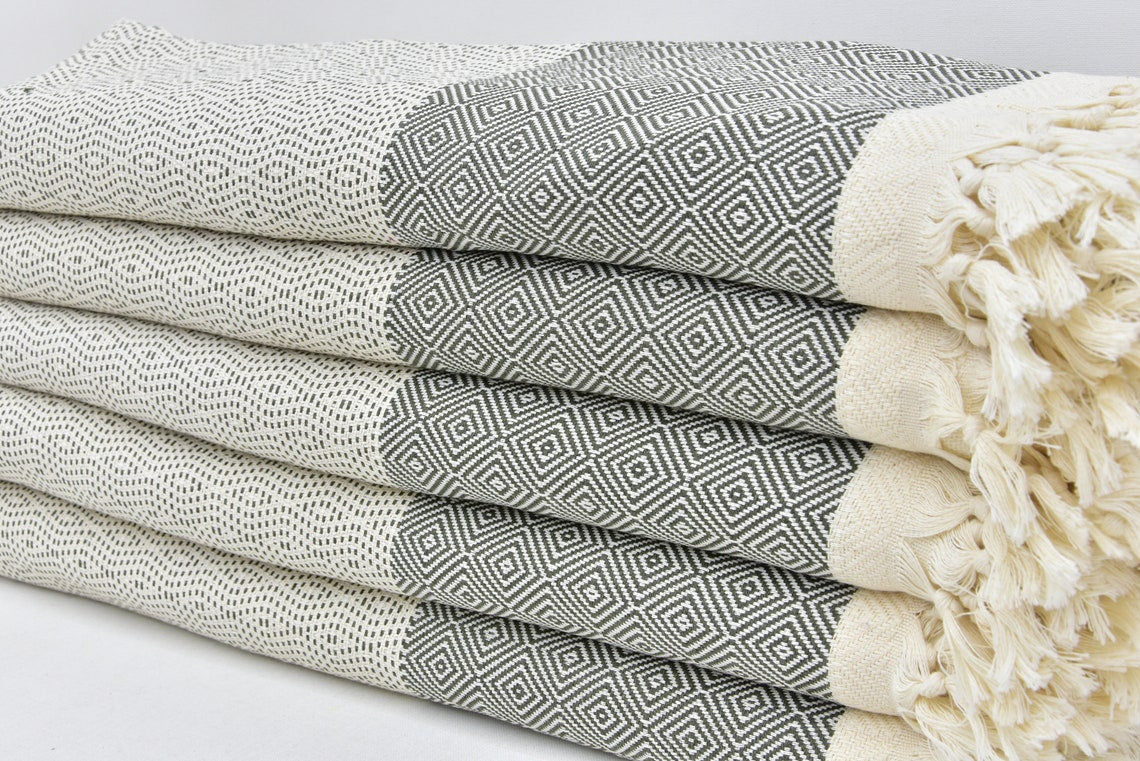 A stylish Hammam towel made from 100% Turkish cotton, featuring a classic herringbone pattern, perfect for beach, yoga, and home use.