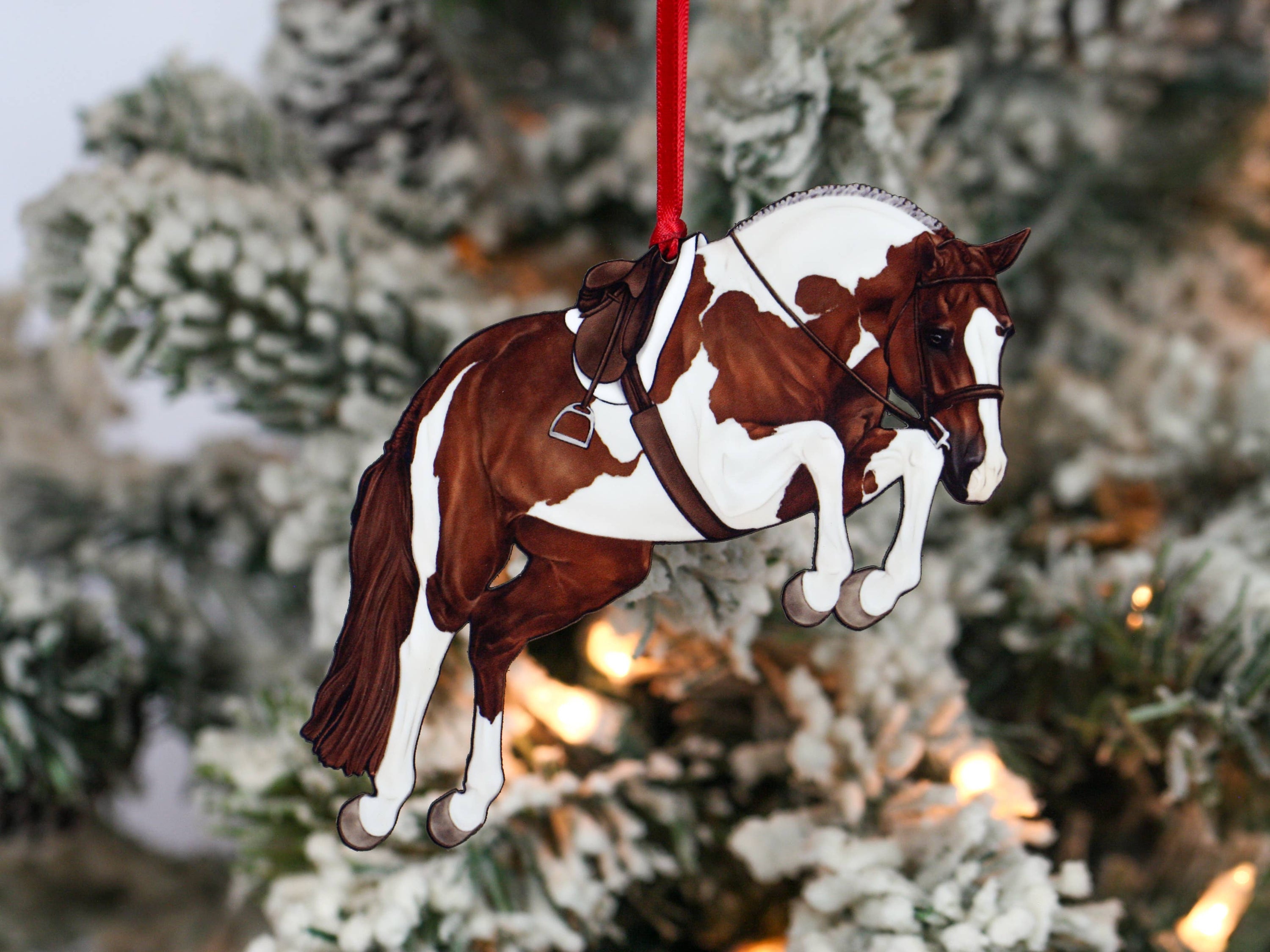 Handcrafted chestnut tobiano hunter jumper horse ornament with red and black ribbons, made from composite wood, perfect for Christmas decoration.