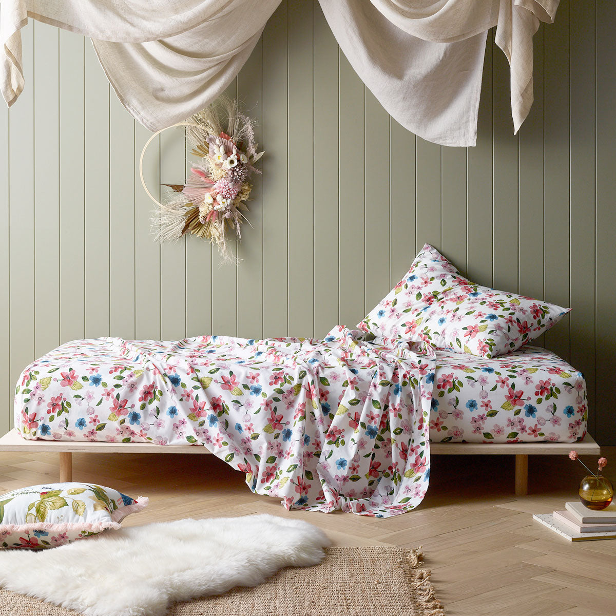 Happy Kids Habitat Printed Cotton Fitted Sheet with floral design and matching pillowcases in vibrant colors.