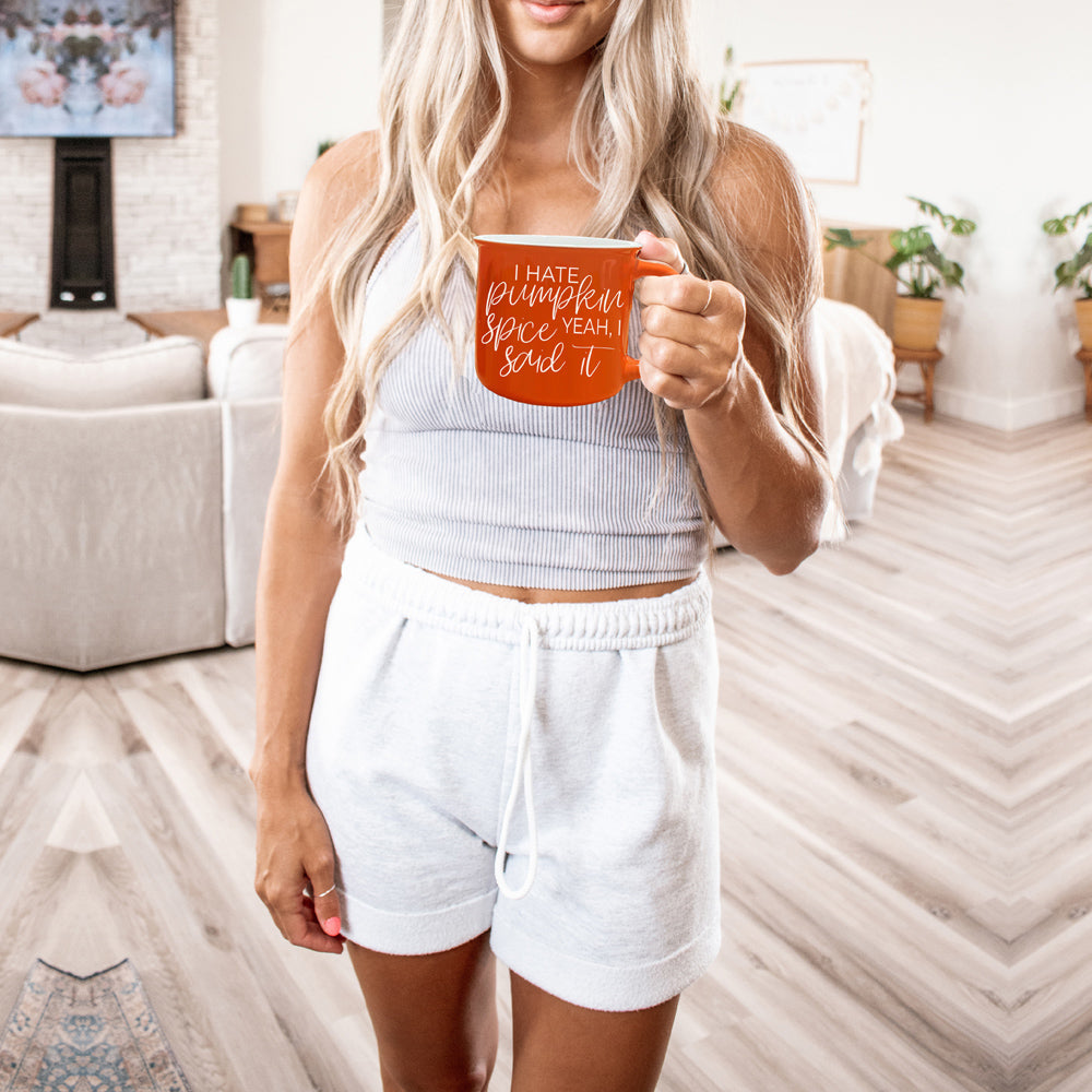 Hate Pumpkin Mug in vibrant orange with white lettering, featuring the phrase 'I hate pumpkin spice, yeah I said it' on both sides.