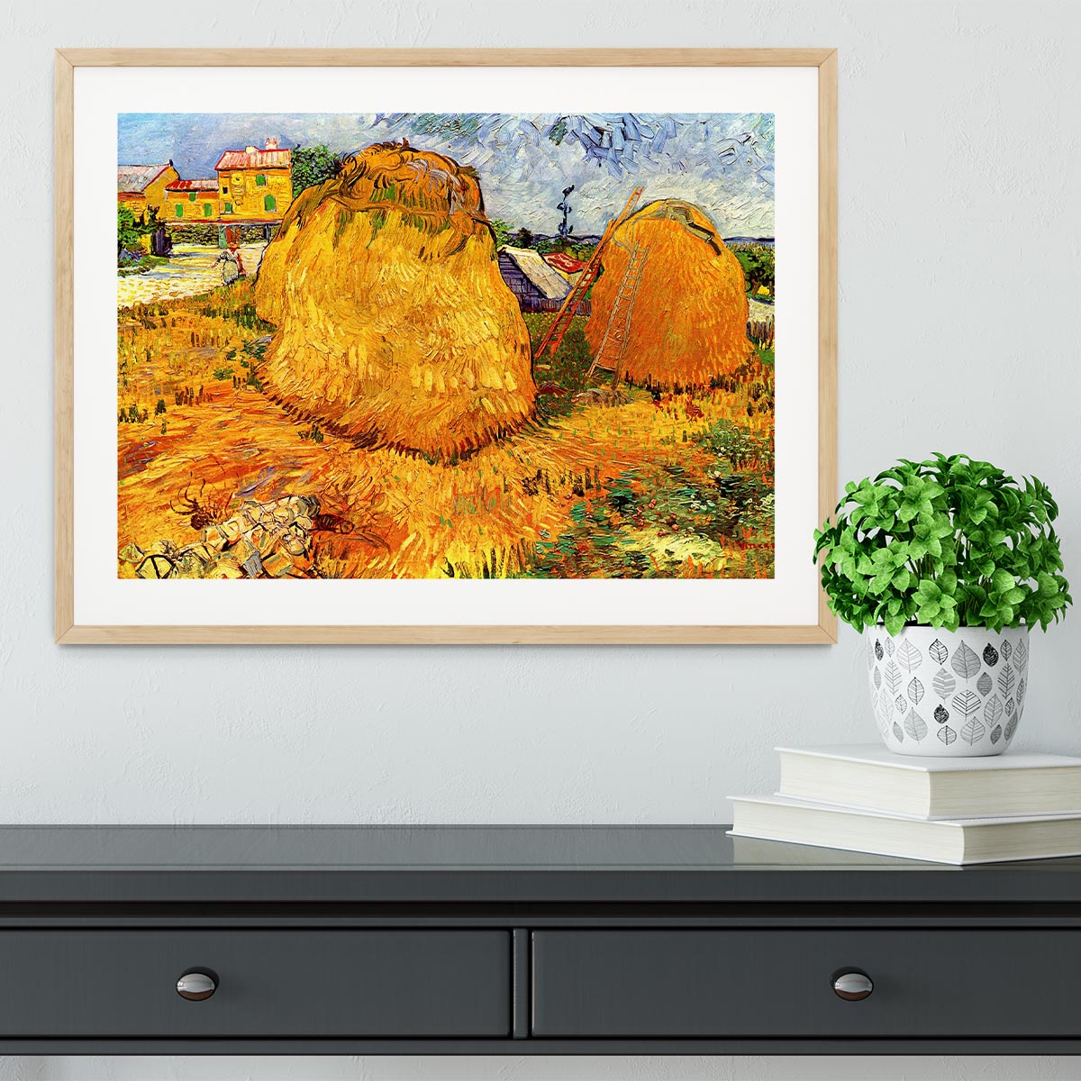 Framed print of Van Gogh's Haystacks in Provence, showcasing vibrant colors and intricate details in a handmade frame.