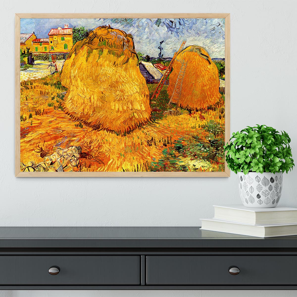 Framed print of Van Gogh's Haystacks in Provence, showcasing vibrant colors and intricate details in a handmade frame.