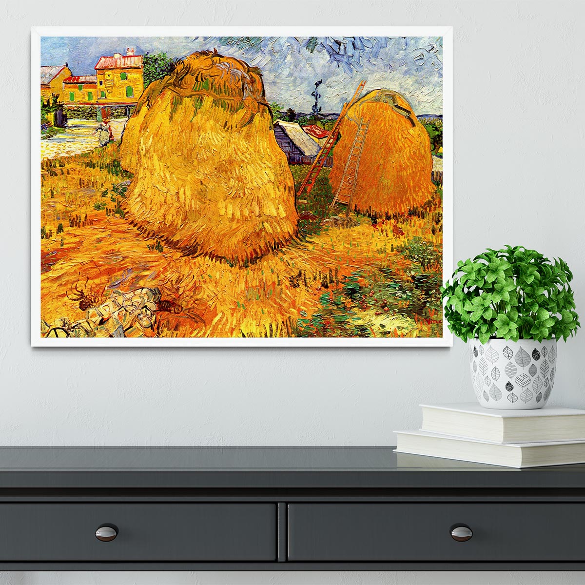 Framed print of Van Gogh's Haystacks in Provence, showcasing vibrant colors and intricate details in a handmade frame.