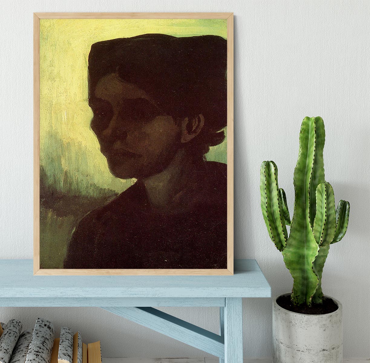 Framed print of Van Gogh's 'Head of a Young Peasant Woman with Dark Cap', showcasing vibrant colors and intricate details.
