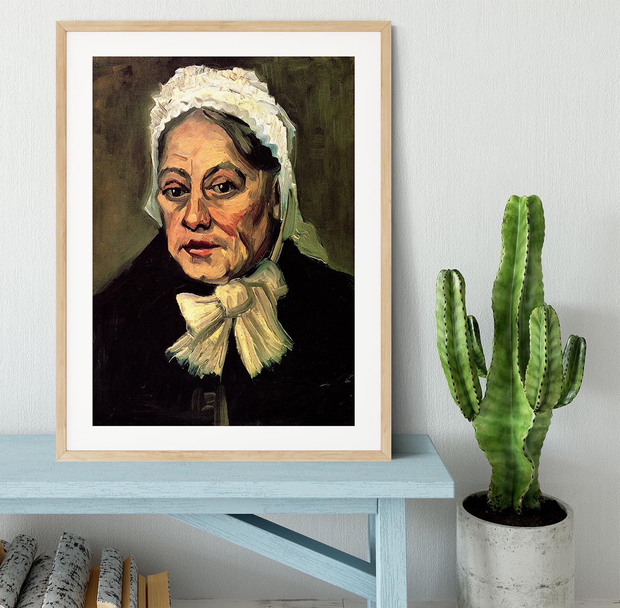 Framed artwork of Van Gogh's 'Head of an Old Woman with White Cap', showcasing intricate details and vibrant colors.