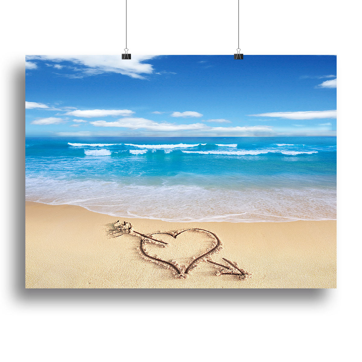 A beautiful canvas print featuring a heart with an arrow drawn in sand, symbolizing love and adventure.