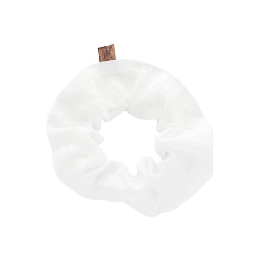 HELGA pellavadonitsi scrunchie in elegant linen fabric, perfect for hair styling and wrist accessory.