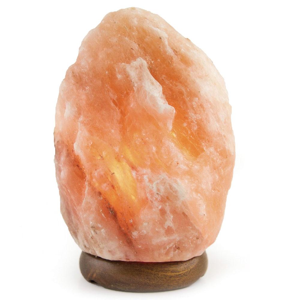A beautifully shaped Himalayan Pink Salt Lamp emitting a warm glow, showcasing its natural rock texture and unique design.