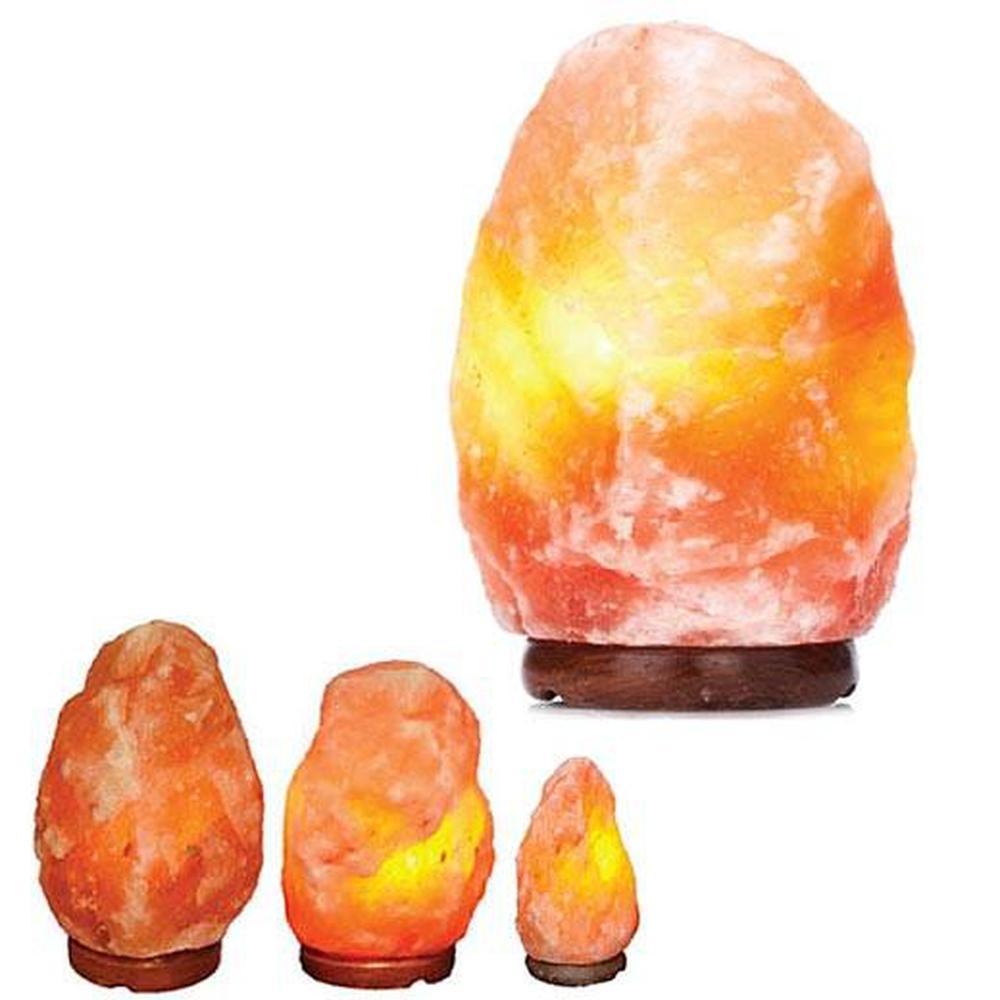 A beautifully shaped Himalayan Pink Salt Lamp emitting a warm glow, showcasing its natural rock texture and unique design.
