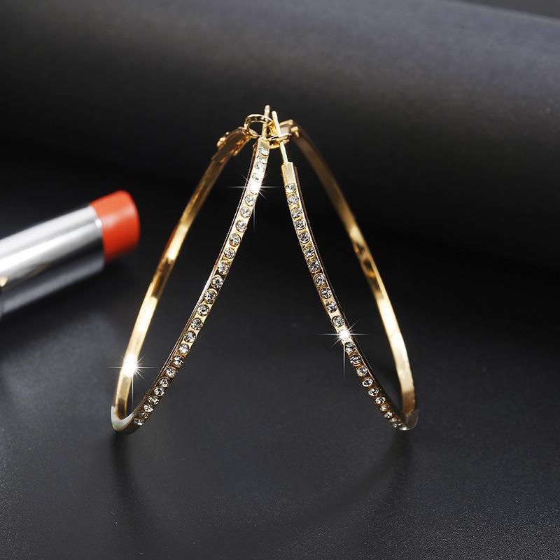 Stylish hoop earrings featuring a unique geometric design inlaid with diamond alloy, showcasing exquisite craftsmanship.