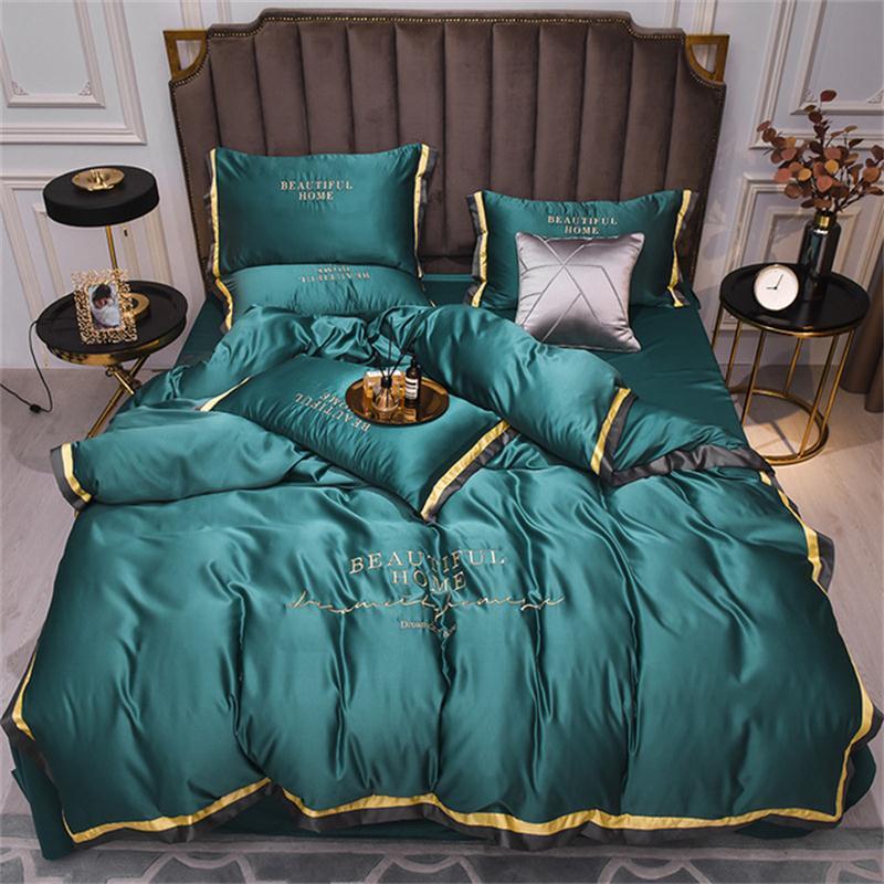Luxurious green silk bedding set featuring a solid design, including duvet cover, bed sheet, and pillowcases.