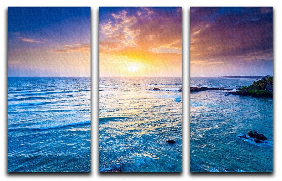 A stunning 3-panel canvas print depicting a vibrant sunset over the Indian Ocean, showcasing rich colors and serene waves.