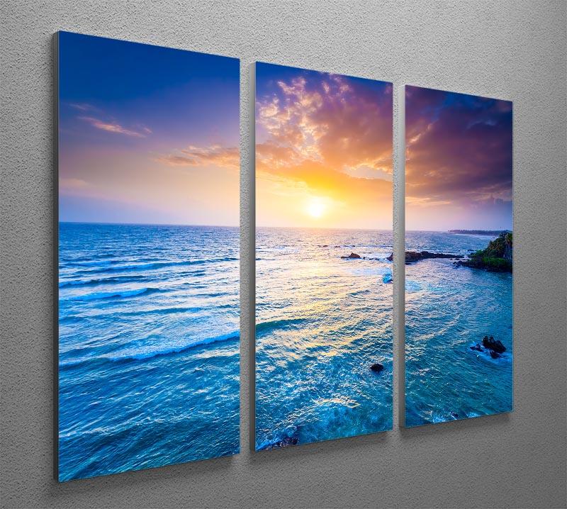 A stunning 3-panel canvas print depicting a vibrant sunset over the Indian Ocean, showcasing rich colors and serene waves.